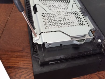 Mit dem beiliegenden Schraubenzieher die Schraube der Festplattenhalterung lösen.